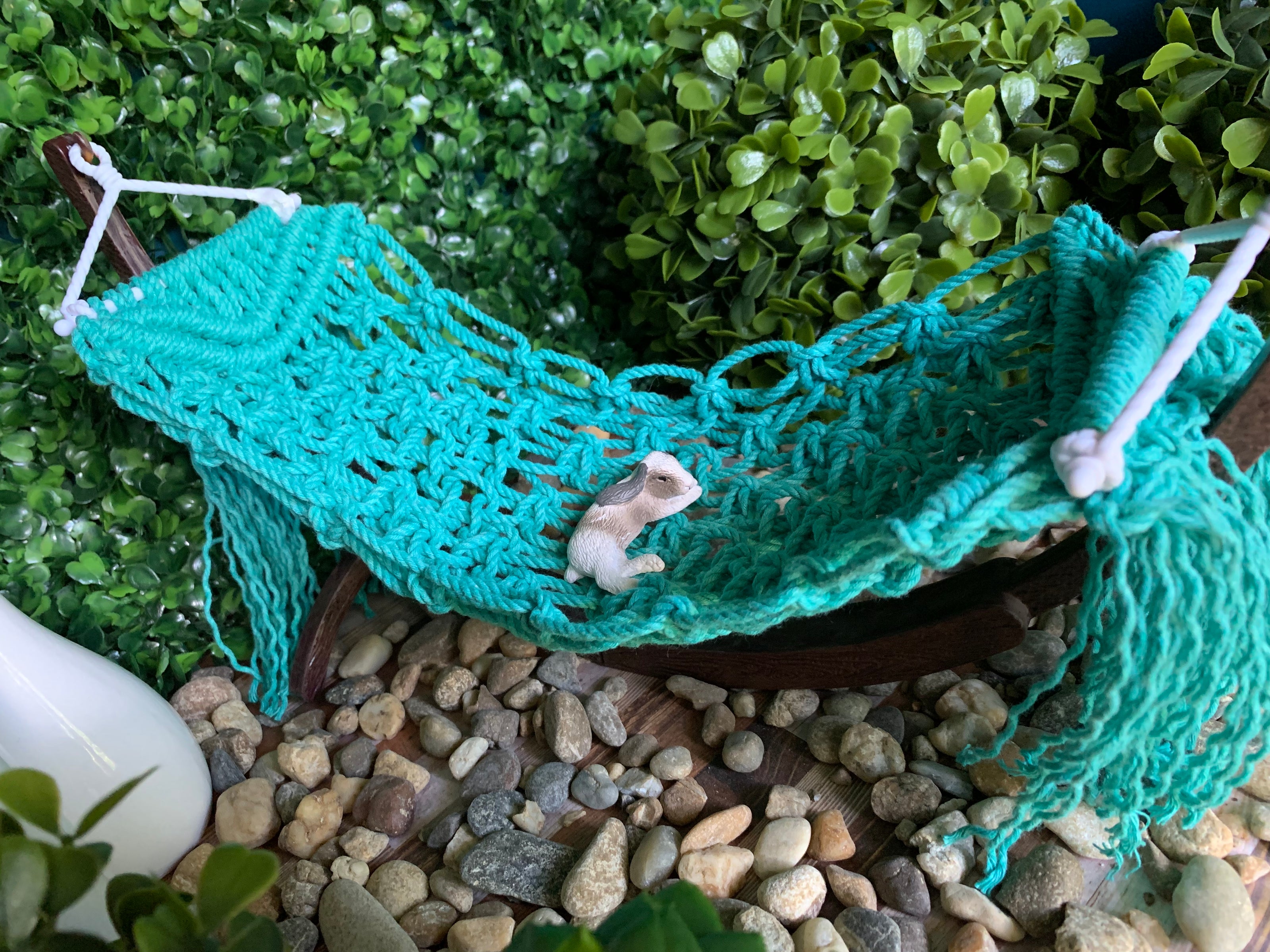 Miniature Bunny toy laying on a 1:6 Scale miniature macrame hammock.